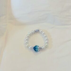 Pearl bracelet with the blue gem in the middle baby bracelet one to 2 inches